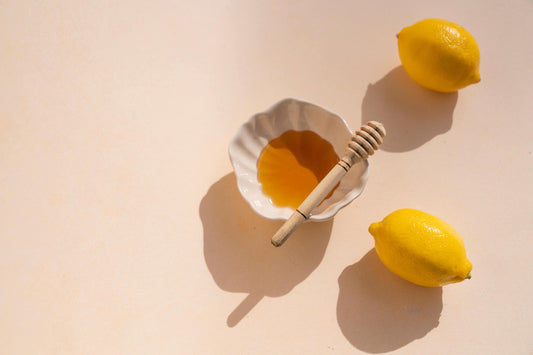 two-lemons-and-white-bowl-with-honey