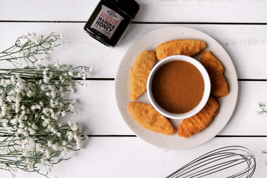 Manuka honey & mustard dipping sauce with bowl of chicken tenders