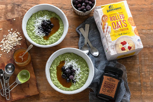 two bowls of matcha bircher, jar of honey and oats