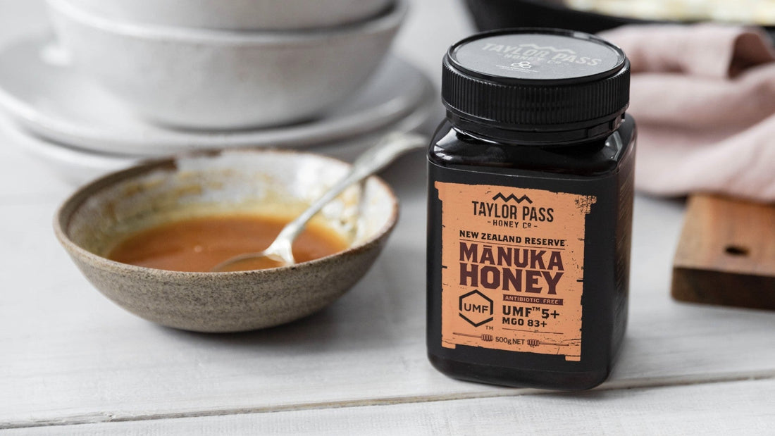 Jar of manuka honey with honey in a dish beside it