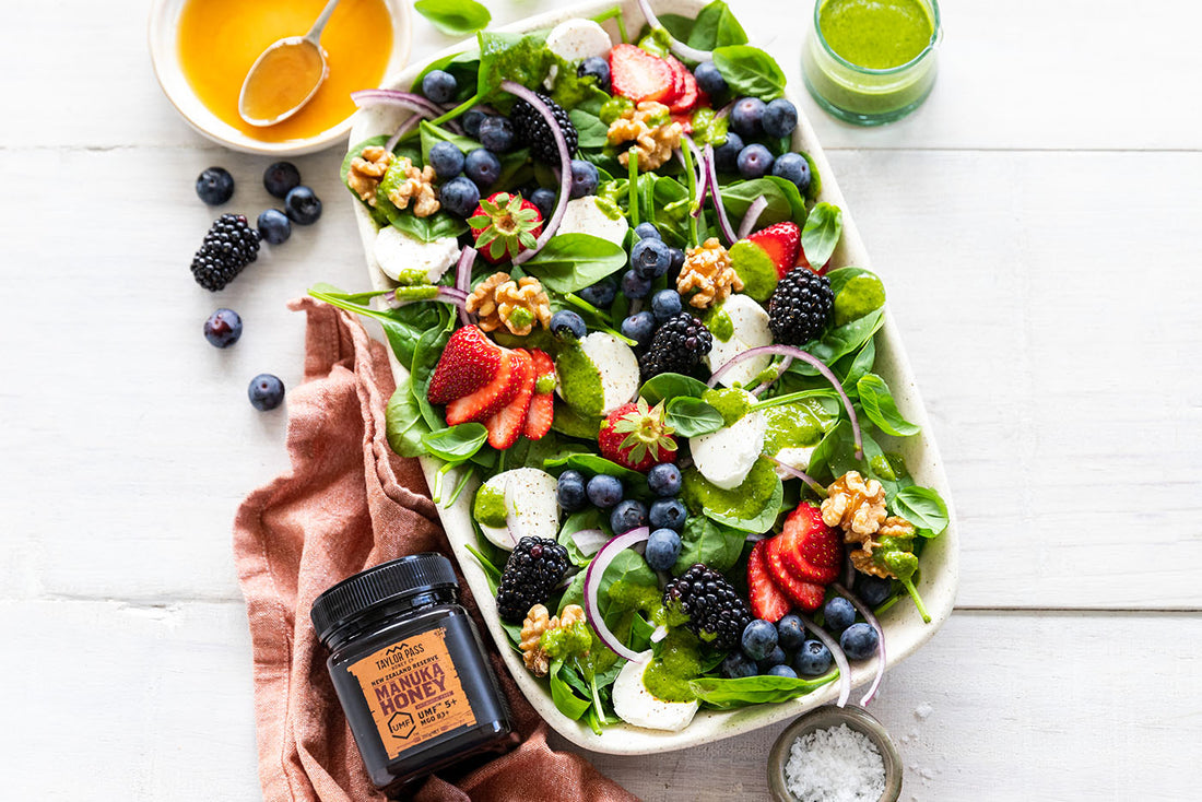 salad in dish with jar of honey