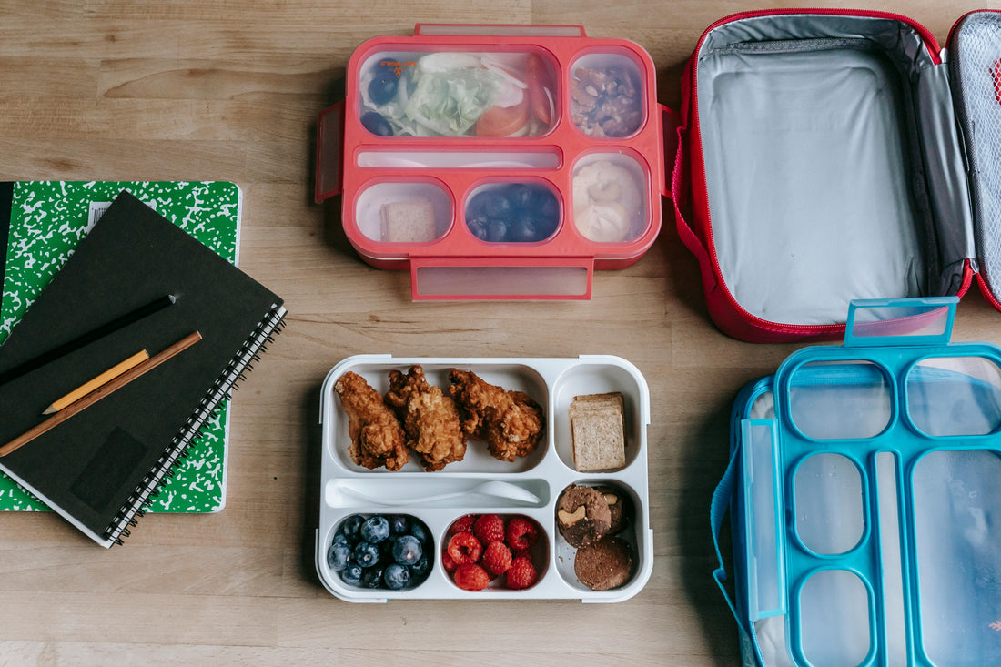 lunch-boxes-and-notebooks-on-table